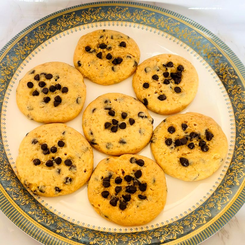 A plate of seven golden chocolate chip cookies
